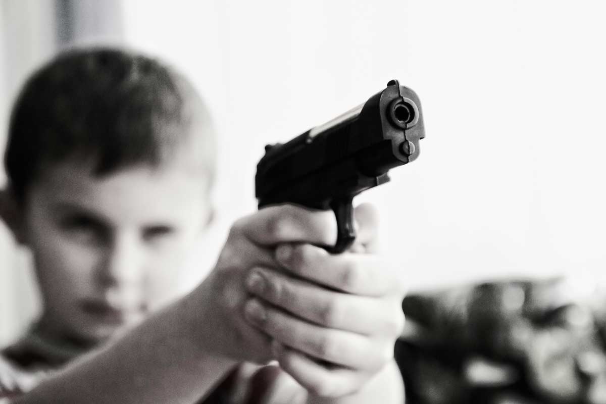 child pointing a gun