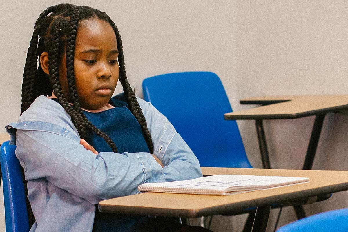 Sad African American girl at school