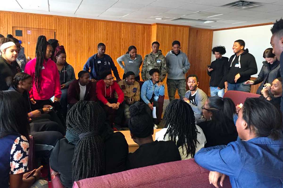 group of young people seated listening to a talk