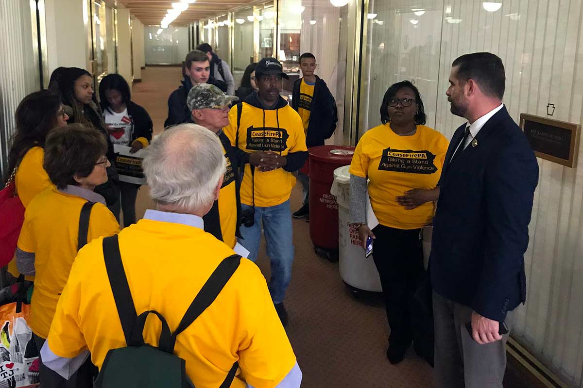 group in hallway listening to elected official